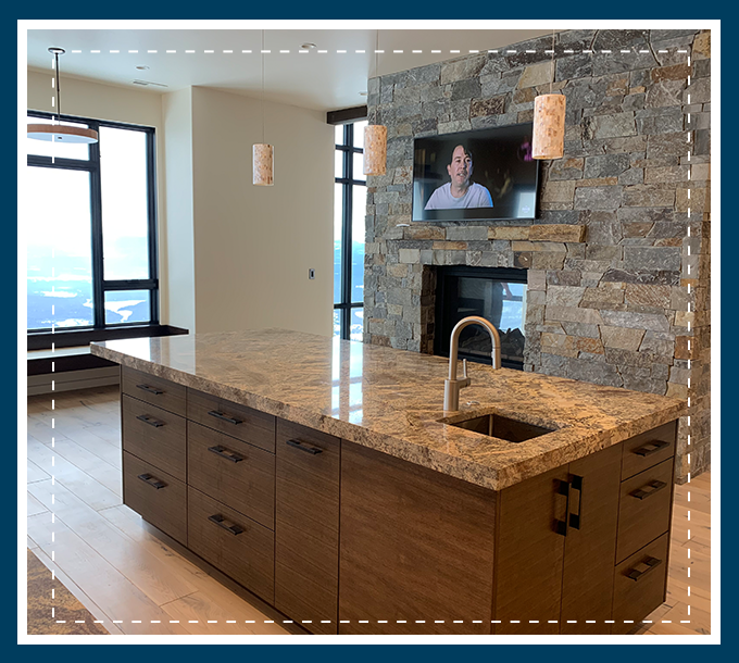 A kitchen with granite counter tops and a large window.