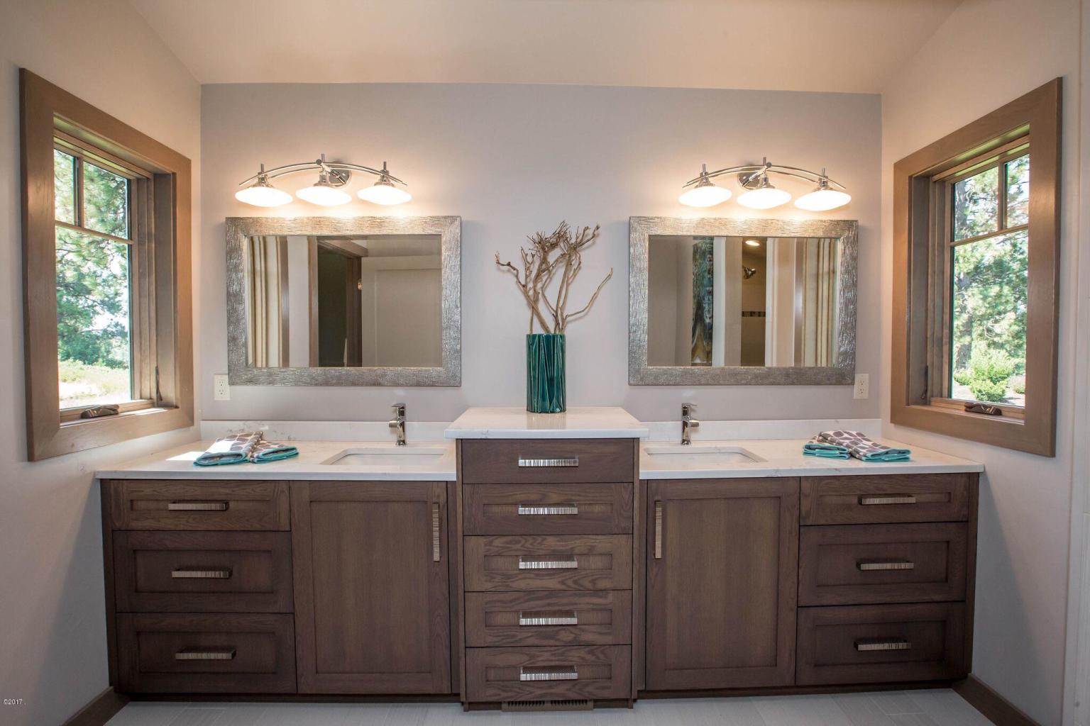 A bathroom with two sinks and mirrors in it