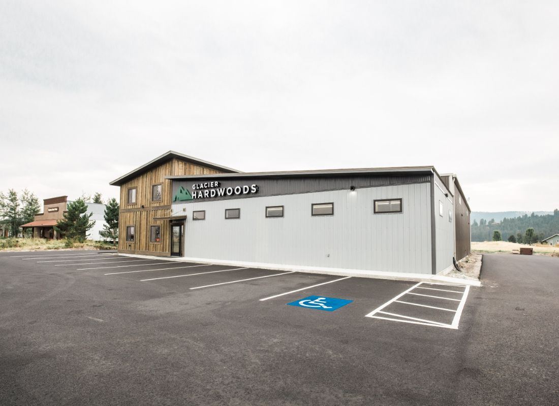 A building with a parking lot in front of it.